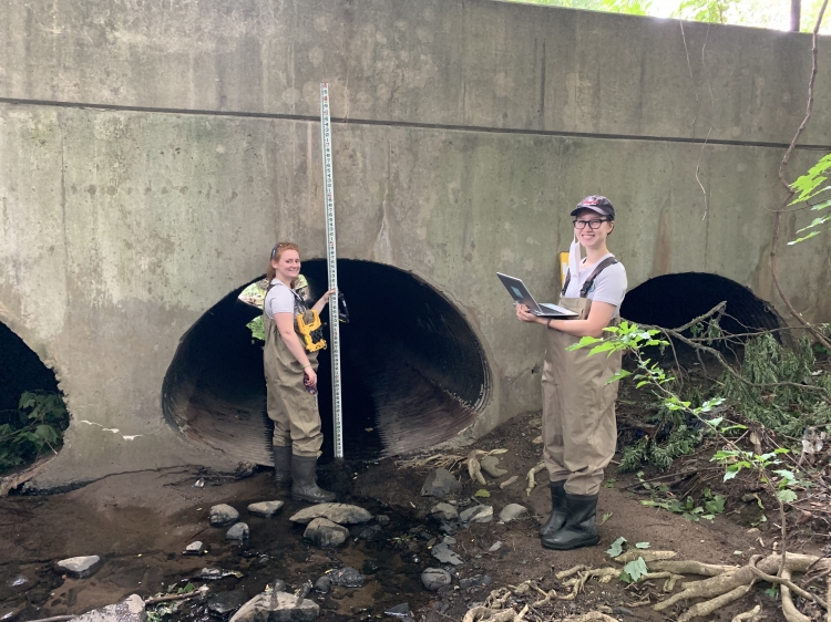 Nika and Meghan measuring a storm drain