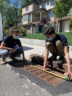 Corps Members measuring a storm drain